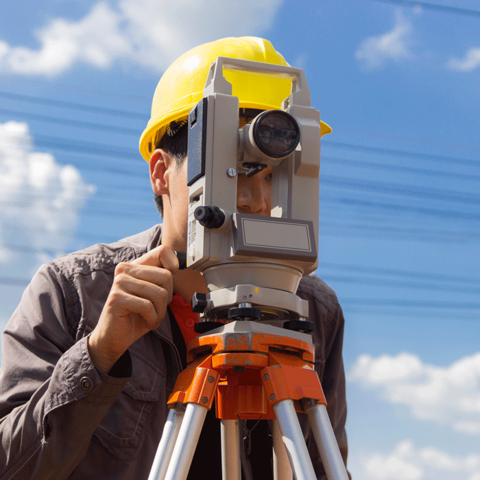 Professional land surveyor from TALA Associates working on a project site in Los Angeles County